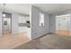 Open-concept living room featuring a view into the kitchen, connecting the carpeted living area to wood floors at 114 Shadowmoss Pkwy, Charleston, SC 29414