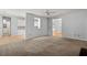 Bright open-concept living area leading to a kitchen and dining room with comfortable carpeting at 114 Shadowmoss Pkwy, Charleston, SC 29414