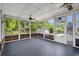 Relaxing screened porch with ceiling fans, wood flooring, and views of the backyard at 114 Shadowmoss Pkwy, Charleston, SC 29414
