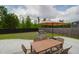 Backyard with a grill, patio umbrella, dining table and fenced yard with grass at 114 W Bradford Pointe Dr, Summerville, SC 29483