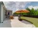 Backyard patio featuring outdoor furniture, grill, and a well-manicured lawn, perfect for relaxing at 114 W Bradford Pointe Dr, Summerville, SC 29483