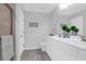 Bright bathroom features a double vanity, gray tile floors, and a tiled shower with glass door at 114 W Bradford Pointe Dr, Summerville, SC 29483