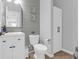 Well-lit half bathroom with modern vanity, toilet, gray shiplap and stylish decor at 114 W Bradford Pointe Dr, Summerville, SC 29483