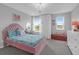 Charming bedroom featuring a pink bed frame, chandelier, desk and ample natural light from two windows at 114 W Bradford Pointe Dr, Summerville, SC 29483