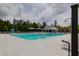 Spacious community pool surrounded by seating and palm trees, ideal for summer relaxation and recreation at 114 W Bradford Pointe Dr, Summerville, SC 29483
