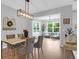 Bright dining space with modern chandelier and open views to an inviting seating area, creating a perfect ambiance at 114 W Bradford Pointe Dr, Summerville, SC 29483