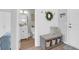 Charming entryway with coat rack, storage bench, and view of a well-appointed half bathroom at 114 W Bradford Pointe Dr, Summerville, SC 29483