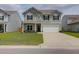 Charming two-story home featuring gray siding, black shutters, a two-car garage, and a well-manicured lawn at 114 W Bradford Pointe Dr, Summerville, SC 29483