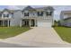 Charming two-story home featuring gray siding, black shutters, a two-car garage, and a well-manicured lawn at 114 W Bradford Pointe Dr, Summerville, SC 29483