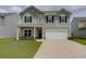 Charming two-story home featuring gray siding, black shutters, a two-car garage, and a well-manicured lawn at 114 W Bradford Pointe Dr, Summerville, SC 29483