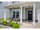 Inviting front porch with stylish seating area, manicured landscaping, and a charming entryway with a decorative wreath at 114 W Bradford Pointe Dr, Summerville, SC 29483