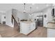 Modern kitchen featuring an island with bar seating and stainless steel appliances, plus adjacent stairway and open floor plan at 114 W Bradford Pointe Dr, Summerville, SC 29483