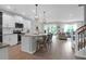 Spacious kitchen with white cabinetry, stainless steel appliances, island with seating, and an open floor plan at 114 W Bradford Pointe Dr, Summerville, SC 29483