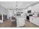 Bright, modern kitchen with a large island, stainless steel appliances, and elegant bar stools for casual dining at 114 W Bradford Pointe Dr, Summerville, SC 29483