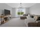 Spacious living room with comfortable seating, large window, and modern entertainment center at 114 W Bradford Pointe Dr, Summerville, SC 29483