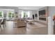Cozy living room features a stone fireplace, large windows with natural light, and stylish furniture at 114 W Bradford Pointe Dr, Summerville, SC 29483