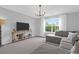 Cozy living room showcasing plush seating, a large window, and an entertainment center at 114 W Bradford Pointe Dr, Summerville, SC 29483
