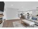 Bright living room with a modern fireplace, open to kitchen area with bar seating, and stairs leading to other floors at 114 W Bradford Pointe Dr, Summerville, SC 29483
