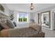 Inviting bedroom with soft bedding, a large window, and a full-length mirror, creating a relaxing atmosphere at 114 W Bradford Pointe Dr, Summerville, SC 29483
