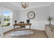 Bright home office with neutral walls, stylish desk, elegant light fixture, and a large window for natural light at 114 W Bradford Pointe Dr, Summerville, SC 29483