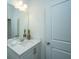 Well-lit bathroom featuring a vanity with a sleek countertop, modern fixtures, and decorative accents at 1204 Twin Rivers Drive, Wando, SC 29492