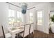 Bright dining area with stylish table and chairs, large windows, and a decorative chandelier at 126 Maritime Way, Summerville, SC 29485