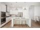 Modern, all-white kitchen with stainless steel appliances, quartz countertops, and a spacious center island at 126 Maritime Way, Summerville, SC 29485