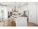 Modern, all-white kitchen with stainless steel appliances, quartz countertops, and a spacious center island at 126 Maritime Way, Summerville, SC 29485