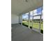 Covered back porch featuring concrete floors and a screened door overlooking a green lawn at 139 Summerwind Dr, Summerville, SC 29486
