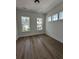 Bright, airy bedroom with hardwood floors and ample natural light from three large windows at 139 Summerwind Dr, Summerville, SC 29486