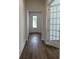 Hallway with hardwood floors leading to a white front door and a room with a glass french door at 139 Summerwind Dr, Summerville, SC 29486