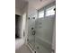 Walk-in shower with clear glass door and white tile surround featuring modern fixtures and a recessed storage nook at 139 Summerwind Dr, Summerville, SC 29486