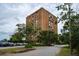 Multi-story building with mature trees and parking at 14 Lockwood Dr # 1-F, Charleston, SC 29401
