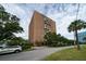 Residential multi-story building featuring lush landscaping and street access at 14 Lockwood Dr # 1-F, Charleston, SC 29401
