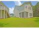 A spacious backyard featuring a screened-in porch and well-maintained lawn at 1425 Clay Field Trl, Summerville, SC 29485