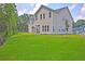 Large backyard area with a grass lawn and a patio with a screened porch at 1425 Clay Field Trl, Summerville, SC 29485