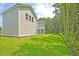 Expansive backyard view featuring lush green grass and tree-lined property at 1425 Clay Field Trl, Summerville, SC 29485