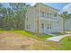 Side view of a two-story house with a two-car garage and landscaping at 1425 Clay Field Trl, Summerville, SC 29485