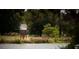 Scenic lake view featuring a quaint birdhouse on stilts and lush greenery at 1425 Clay Field Trl, Summerville, SC 29485