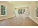 Bright living room featuring hardwood floors and multiple windows with tree views at 1425 Clay Field Trl, Summerville, SC 29485