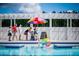 Community Pool with a colorful umbrella and beach ball, making it fun for all ages at 1425 Clay Field Trl, Summerville, SC 29485