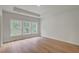 Light-filled bedroom with tray ceiling, large windows, hardwood floors, and recessed lighting at 157 Threaded Fern St, Summerville, SC 29485