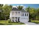 Charming two-story home featuring a covered porch, attached garage, and professionally landscaped yard at 157 Threaded Fern St, Summerville, SC 29485
