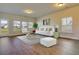 Bright living room with hardwood floors, large windows, contemporary furnishings and lots of natural light at 157 Threaded Fern St, Summerville, SC 29485