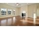 Inviting living room with large windows, gas fireplace, ceiling fan and hardwood floors at 157 Threaded Fern St, Summerville, SC 29485