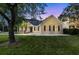 Charming single-story home featuring a well-maintained lawn and inviting curb appeal at sunset at 1725 Henley Ln, Charleston, SC 29412