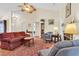 Spacious living room featuring a ceiling fan, fireplace, and warm natural light at 1725 Henley Ln, Charleston, SC 29412