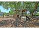 Community playground with climbing equipment, slides, and a sprawling canopy of shade trees at 1725 Henley Ln, Charleston, SC 29412