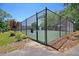 Enclosed tennis court with black fence and greenery, perfect for active recreation in the community at 1725 Henley Ln, Charleston, SC 29412