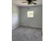 Bedroom with gray carpet and walls features a ceiling fan and a window at 1735 Boone Hall Dr # K6, Charleston, SC 29407